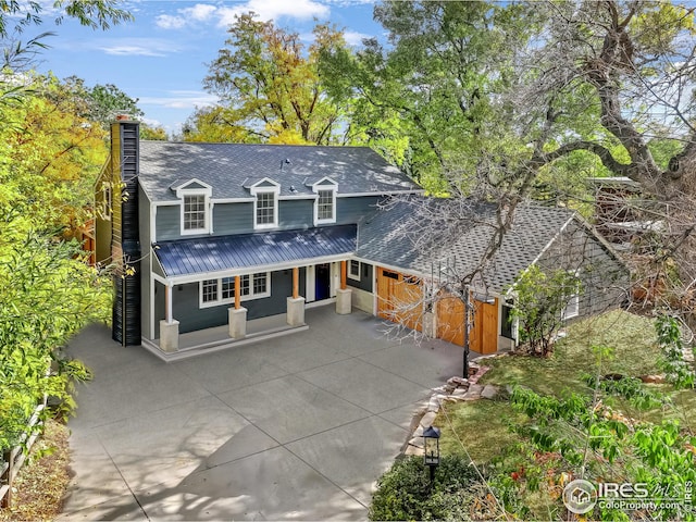 view of front of home featuring a porch and a garage