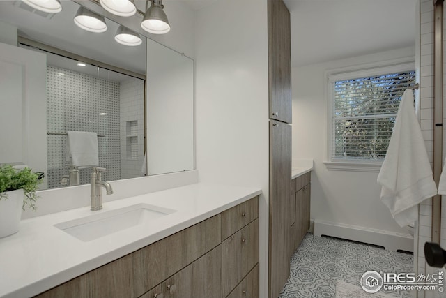 bathroom with tile patterned floors, vanity, and a shower with door