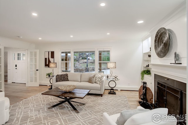 living room with french doors, light hardwood / wood-style flooring, and crown molding