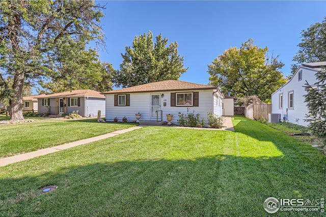 single story home with a front yard and central AC