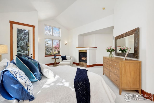 carpeted bedroom with access to outside and vaulted ceiling