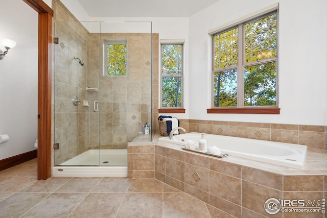 bathroom with tile patterned flooring and separate shower and tub