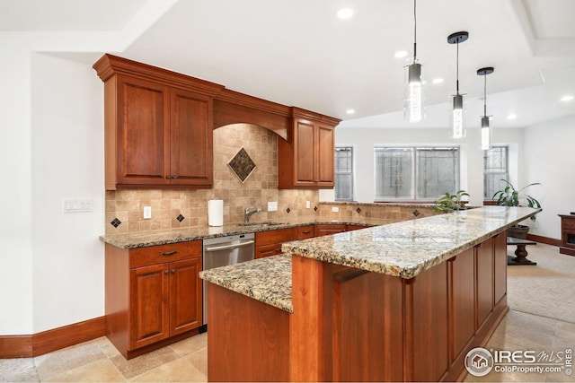 kitchen with light stone countertops, a center island, sink, backsplash, and pendant lighting