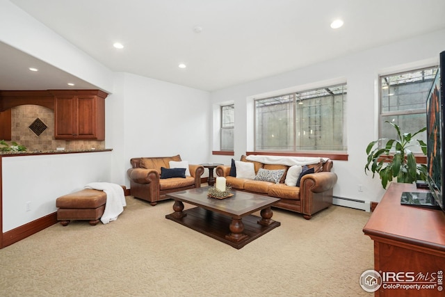 living room with light carpet and a baseboard heating unit