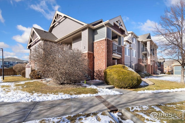 snow covered property featuring a balcony