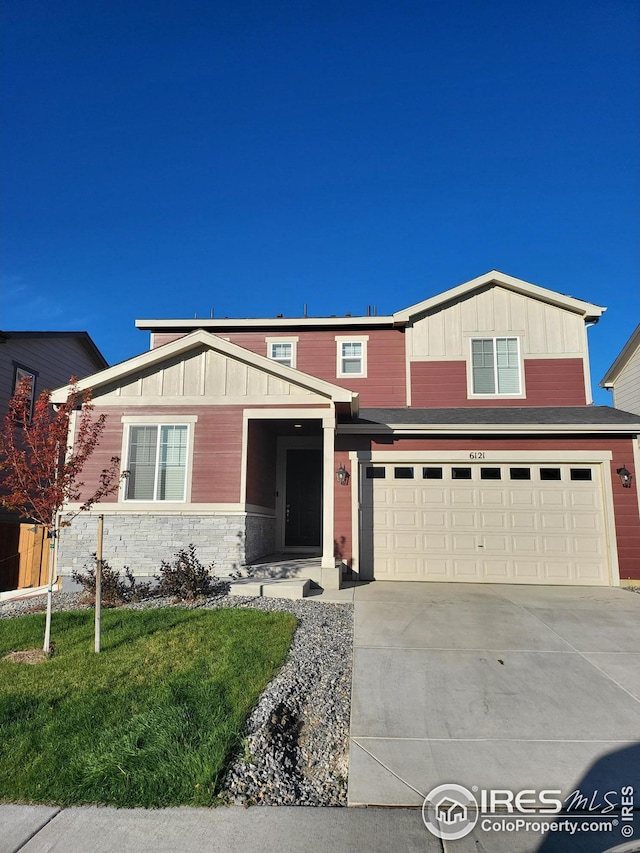 view of front of home with a front yard and a garage