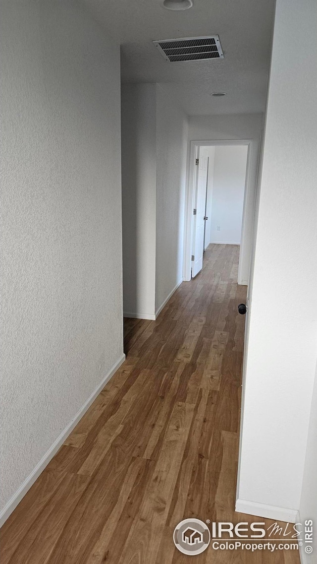 hall with dark hardwood / wood-style floors