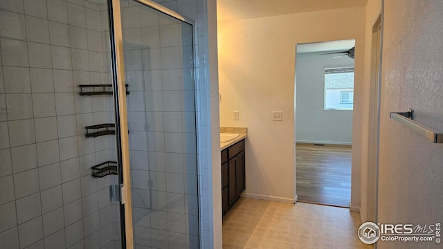 bathroom featuring vanity and an enclosed shower