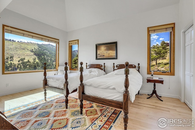 bedroom with light wood-type flooring and baseboards