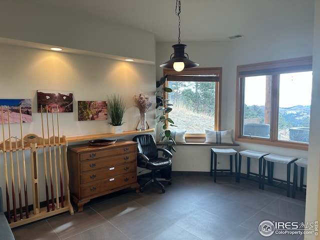 office area featuring tile patterned flooring, visible vents, and a healthy amount of sunlight