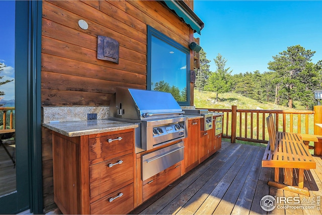 deck with area for grilling and an outdoor kitchen