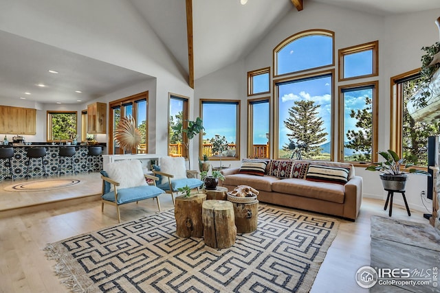 living area with beam ceiling, recessed lighting, wood finished floors, and high vaulted ceiling