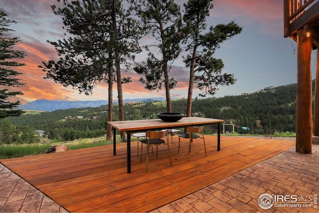 deck featuring a mountain view and a wooded view