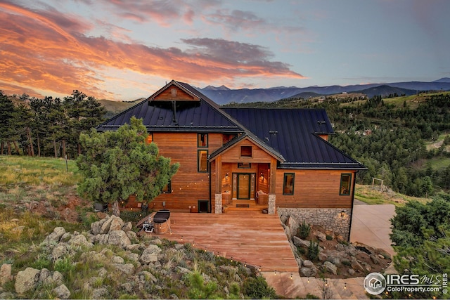rustic home with a mountain view, metal roof, and a standing seam roof