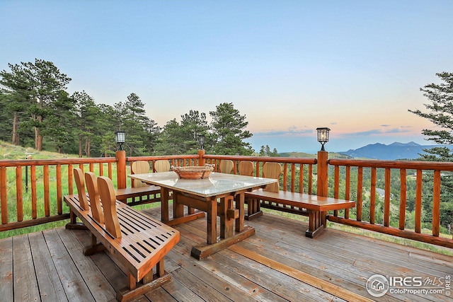 deck at dusk with outdoor dining space