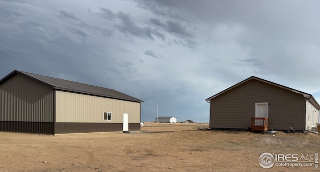 view of home's exterior featuring an outdoor structure and a pole building