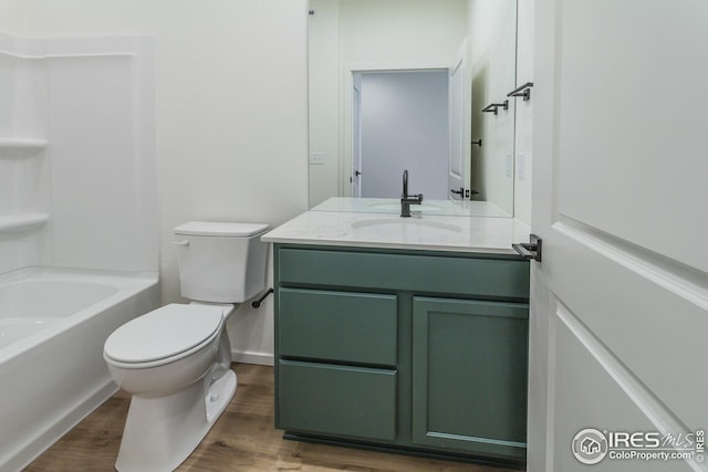 full bathroom featuring wood-type flooring, toilet, vanity, and shower / tub combination