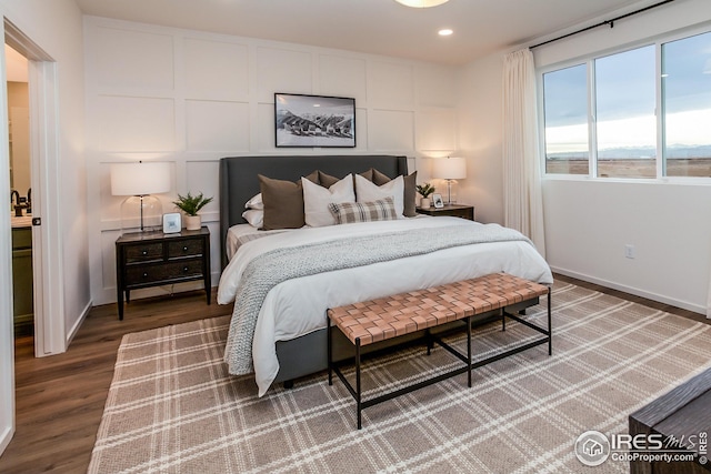 bedroom with dark hardwood / wood-style floors