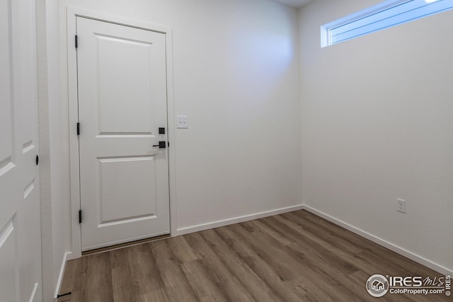 entryway with hardwood / wood-style floors