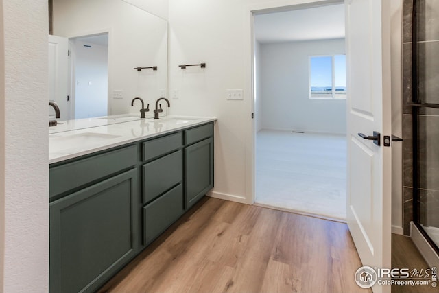 bathroom featuring hardwood / wood-style flooring and vanity