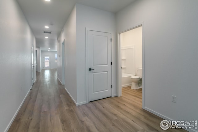 hallway with light hardwood / wood-style flooring