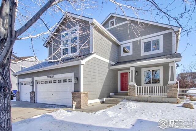 view of front of home with covered porch and a garage