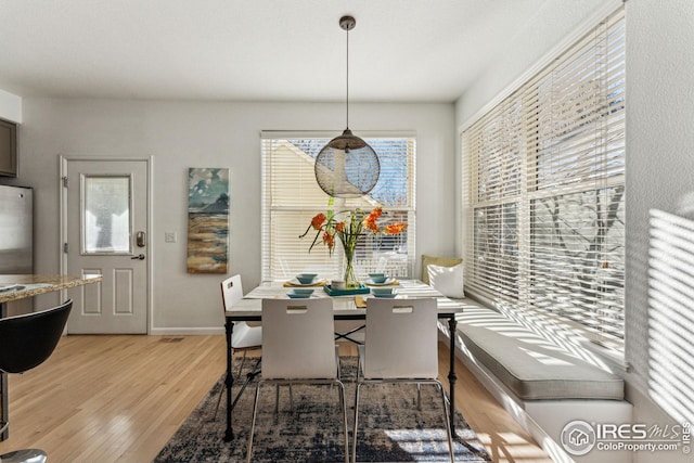 dining room featuring light wood-style floors and baseboards