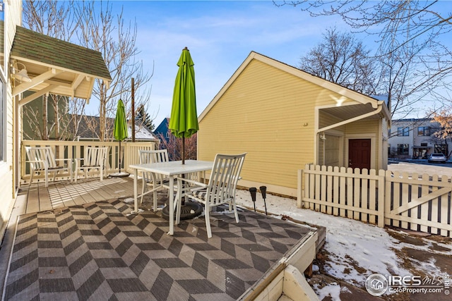 view of patio / terrace featuring fence, outdoor dining area, and a wooden deck