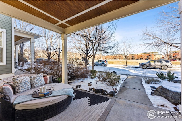 snow covered patio featuring outdoor lounge area