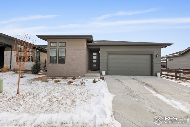 ranch-style home featuring a garage and central AC