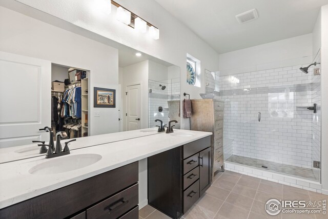 bedroom with ensuite bath, ceiling fan, and light colored carpet