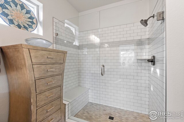 bathroom with tile patterned floors, vanity, and a shower with door