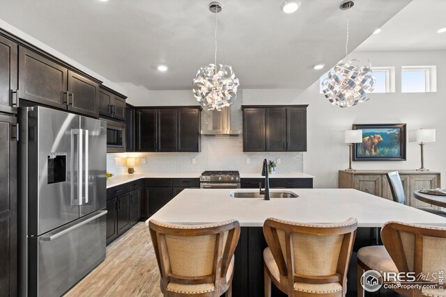 dining area featuring sink, a chandelier, and light wood-type flooring