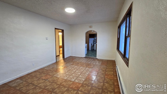 unfurnished room with a textured ceiling