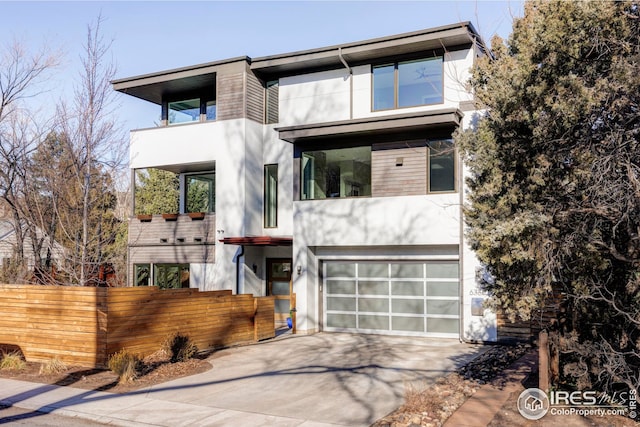 contemporary home with a garage and a balcony