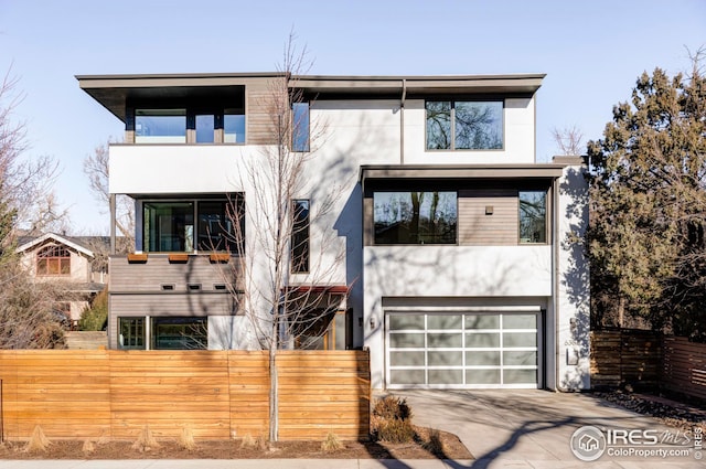 contemporary house featuring a garage and a balcony