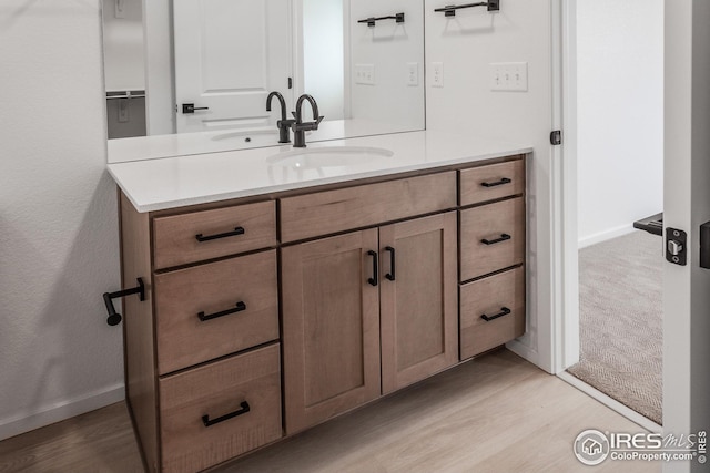 bathroom featuring vanity and wood-type flooring