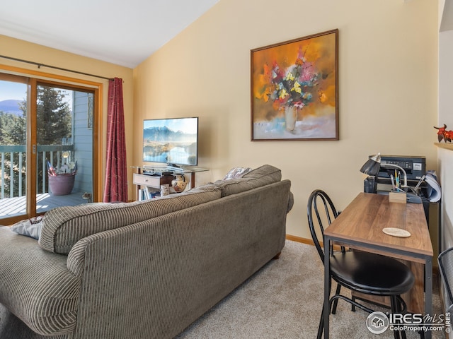 carpeted living room featuring vaulted ceiling and baseboards