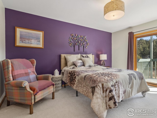 bedroom featuring access to exterior and carpet flooring