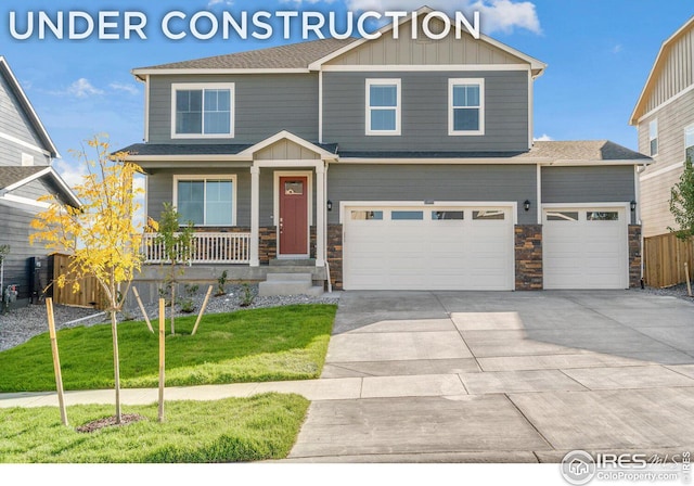 craftsman-style house featuring a garage, a front lawn, and a porch