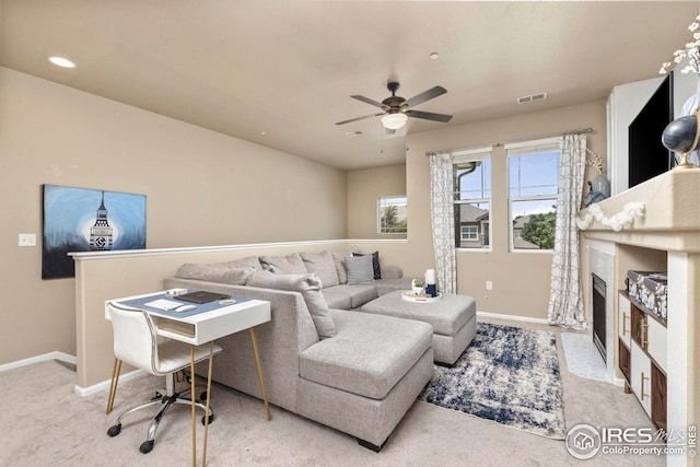 carpeted living room featuring baseboards, visible vents, ceiling fan, a fireplace, and recessed lighting