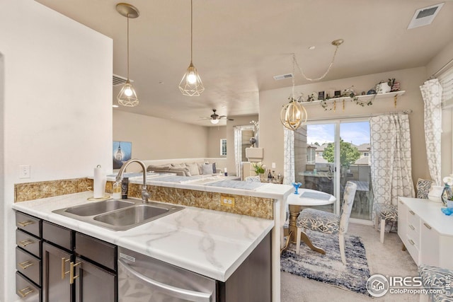 kitchen featuring a sink, visible vents, open floor plan, light countertops, and dishwasher