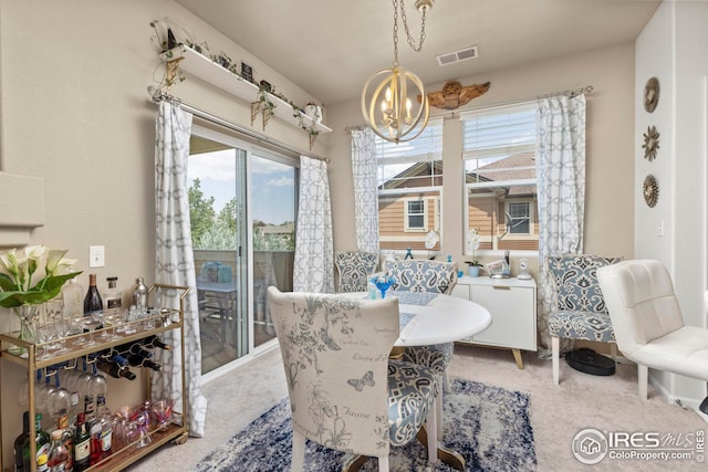 dining room featuring a chandelier, visible vents, and carpet flooring