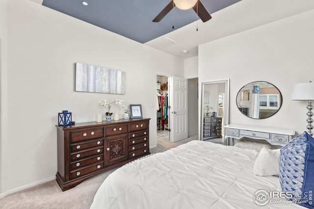 bedroom with ceiling fan, baseboards, a spacious closet, a closet, and carpet