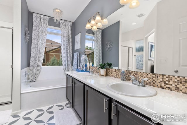 full bath with a garden tub, a shower stall, visible vents, and a sink