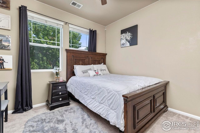 bedroom with baseboards, ceiling fan, visible vents, and light colored carpet