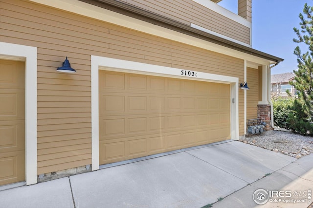 garage with concrete driveway