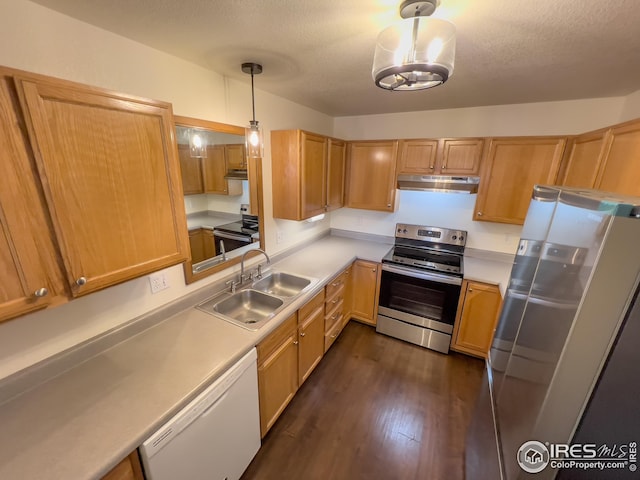 kitchen with pendant lighting, sink, appliances with stainless steel finishes, a textured ceiling, and dark hardwood / wood-style flooring