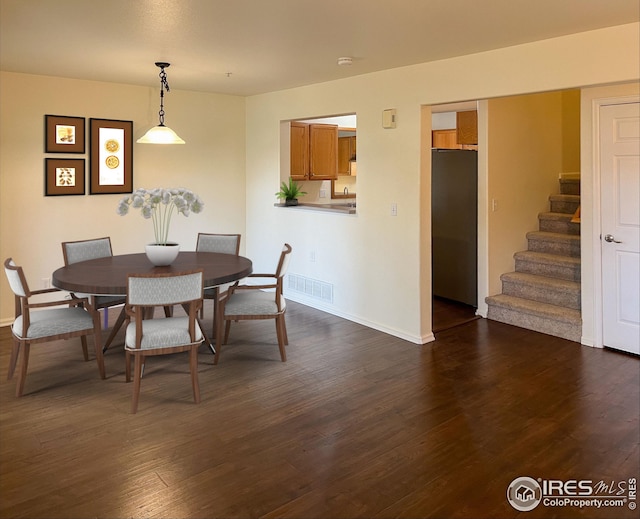 dining room with dark hardwood / wood-style flooring