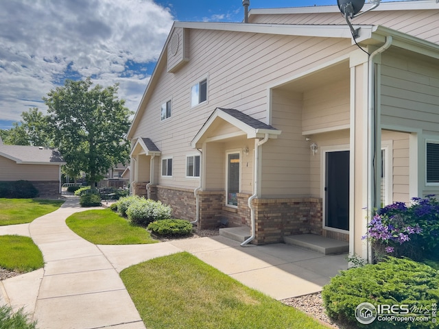 view of property exterior with a yard